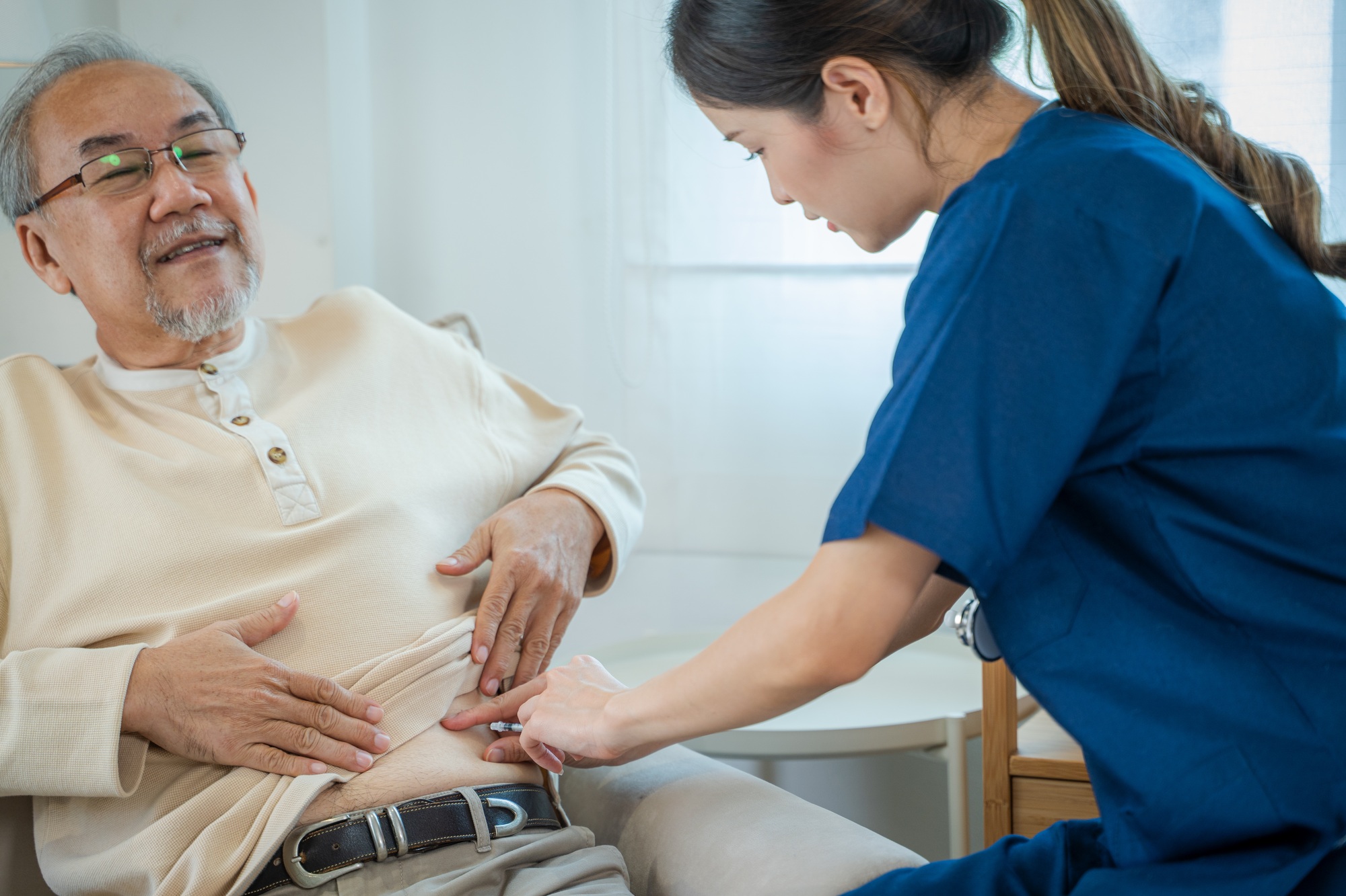 Nurse injects a diabetic injection on a patient's stomach,Medical treatment.